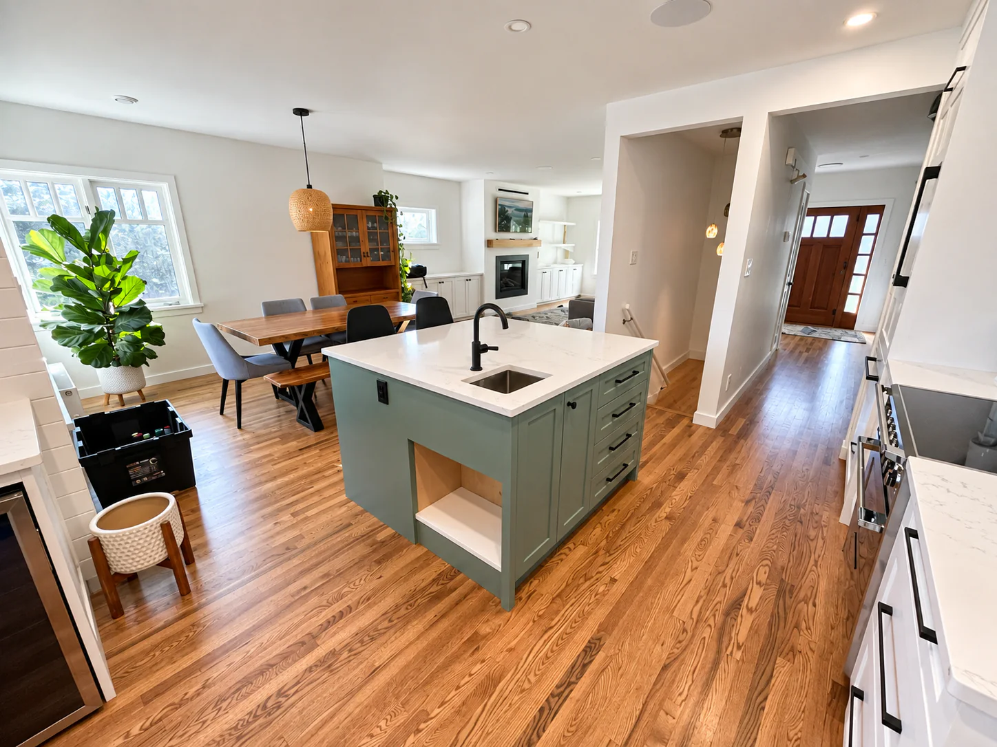 Open plan kitchen with a large island and hardwood floors, renovated by DM Patterson Construction